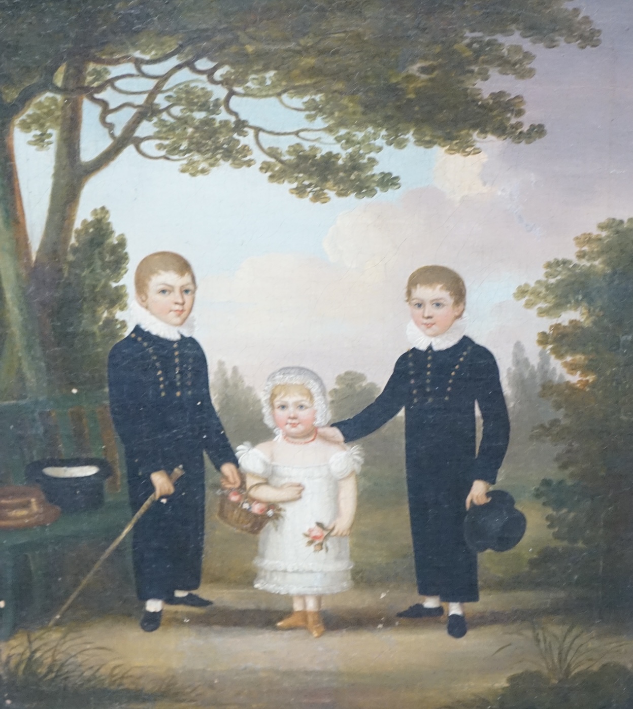 Early 19th century, English School, naive oil on canvas, Three children before a landscape, 38 x 32cm. Condition - fair, craquelure throughout